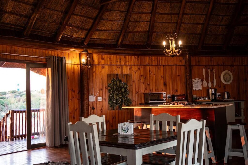 Cozy communal lodge dining room in Kalahari with natural wood interiors and open view