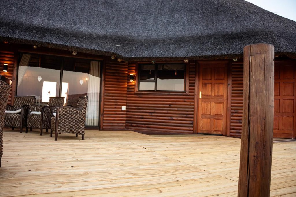 Entrance and seating area on the wooden deck of a luxury Kalahari hunting lodge